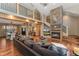 Spacious living area showcases an open concept design, hardwood floors, and stone fireplace at 14582 Homestead Pl, Broomfield, CO 80023