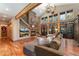 Open living room boasts soaring ceilings, large windows, a fireplace, and hardwood floors at 14582 Homestead Pl, Broomfield, CO 80023