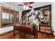 Bright office space with hardwood floors, shutters, accent wall, and custom shelving at 14582 Homestead Pl, Broomfield, CO 80023