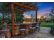 Outdoor kitchen with stone counter, bar seating, and built-in grill, perfect for outdoor entertaining at 14582 Homestead Pl, Broomfield, CO 80023
