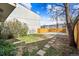 Spacious backyard with a mix of grass and gravel, including a patio and garden area at 2322 Arapahoe St, Denver, CO 80205