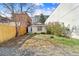 Cozy backyard featuring a small garden area and a quaint, single-story house with charming architectural details at 2322 Arapahoe St, Denver, CO 80205