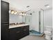 Modern bathroom with a double vanity, glass shower, and contemporary fixtures at 2322 Arapahoe St, Denver, CO 80205