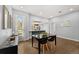 Bright dining area with hardwood floors next to a modern kitchen with stainless appliances at 2322 Arapahoe St, Denver, CO 80205