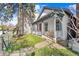 Quaint home with a classic front porch, showcasing architectural details and a well-maintained yard at 2322 Arapahoe St, Denver, CO 80205