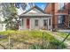 Charming single-story home with a welcoming front porch, featuring a bright red door and lovely curb appeal at 2322 Arapahoe St, Denver, CO 80205