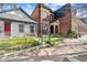 Property featuring a charming home with quaint porch next to a historic brick building at 2322 Arapahoe St, Denver, CO 80205