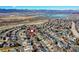 Community aerial view with a pin on one home, featuring mountain and lake views in the background at 3224 White Oak St, Highlands Ranch, CO 80129