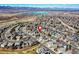 An aerial view showcases a residential area with a pin on one of the houses in a neighborhood, with a scenic background at 3224 White Oak St, Highlands Ranch, CO 80129