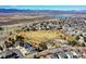 Stunning aerial view of the community with a lake and mountains in the distance, near a park and playground at 3224 White Oak St, Highlands Ranch, CO 80129