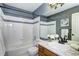 Bathroom with a combination shower/tub, granite vanity, and white-tiled walls at 3224 White Oak St, Highlands Ranch, CO 80129