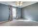 Carpeted bedroom with a ceiling fan, light blue walls and a bright window at 3224 White Oak St, Highlands Ranch, CO 80129