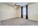 A bright, carpeted bedroom with a ceiling fan and window with blinds at 3224 White Oak St, Highlands Ranch, CO 80129