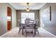 Elegant dining room with a traditional chandelier and a view into the kitchen at 3224 White Oak St, Highlands Ranch, CO 80129