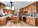 Spacious kitchen featuring wood cabinets, stainless steel appliances, and a center island at 3224 White Oak St, Highlands Ranch, CO 80129