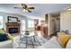 Inviting living room with a stone fireplace, hardwood floors, and an open layout to the kitchen at 3224 White Oak St, Highlands Ranch, CO 80129