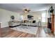 Bright living room featuring neutral paint, wood floors, comfortable seating, and a stone fireplace at 3224 White Oak St, Highlands Ranch, CO 80129