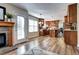 Living room view with hardwood floors, fireplace, and open design through kitchen and to outside at 3224 White Oak St, Highlands Ranch, CO 80129