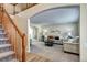 Inviting living room with staircase features plush carpeting, neutral tones, and an arched entryway at 3224 White Oak St, Highlands Ranch, CO 80129