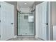 Modern shower with glass doors, tiled walls, and dual shower heads at 3224 White Oak St, Highlands Ranch, CO 80129