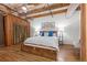 Spacious bedroom features exposed beams, wood flooring, and a cozy Murphy bed at 1745 Wazee St # 3C, Denver, CO 80202