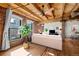 Comfortable living room with large windows, exposed brick, and wood-beamed ceiling at 1745 Wazee St # 3C, Denver, CO 80202