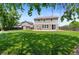 Spacious backyard with lush green grass, a patio area, and a charming shed, perfect for outdoor enjoyment at 201 Shenandoah Way, Brighton, CO 80603