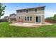 Inviting backyard featuring a well-maintained lawn, patio with swing, and a charming shed for added outdoor appeal at 201 Shenandoah Way, Brighton, CO 80603