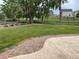 A beautifully landscaped backyard with a stamped concrete patio and views of the grassy common area behind the home at 201 Shenandoah Way, Brighton, CO 80603