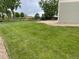 Spacious backyard features a lush lawn and concrete patio area, perfect for outdoor gatherings at 201 Shenandoah Way, Brighton, CO 80603