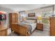 Cozy bedroom with an armoire, plush bedding, and natural light from two windows at 201 Shenandoah Way, Brighton, CO 80603