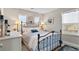Charming bedroom with a decorative iron bed frame, complemented by bright natural light and tasteful artwork at 201 Shenandoah Way, Brighton, CO 80603