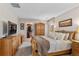 Comfortable bedroom featuring an armoire, dresser, plush bedding, and walk-in closet at 201 Shenandoah Way, Brighton, CO 80603