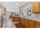 Bright kitchen featuring wooden cabinets, stainless steel appliances, and an open layout to the dining area at 201 Shenandoah Way, Brighton, CO 80603