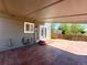 View of the covered patio with access to the home, featuring stained concrete and outdoor electrical outlets at 17212 E Oberlin Pl, Aurora, CO 80013