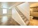 Basement entryway and stairs leading to a tiled rec room, next to a bathroom at 17212 E Oberlin Pl, Aurora, CO 80013