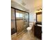 Updated bathroom features a dark vanity, with a beautiful glass shower, and tiled walls at 17212 E Oberlin Pl, Aurora, CO 80013