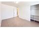 This bedroom features neutral paint, and a large closet with shelving for ample storage at 17212 E Oberlin Pl, Aurora, CO 80013