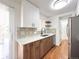 Bright kitchen featuring white cabinets, stainless steel appliances, and modern countertops at 17212 E Oberlin Pl, Aurora, CO 80013