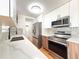Well-lit kitchen featuring stainless steel appliances and modern cabinetry at 17212 E Oberlin Pl, Aurora, CO 80013