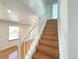 Bright stairway with wood steps and white banister leads to the upper level of the home at 17212 E Oberlin Pl, Aurora, CO 80013