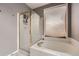 Bright bathroom features a soaking tub with a shower and white tile surround and a large window at 5136 S Ceylon St, Centennial, CO 80015