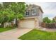 Charming two-story home boasts a two-car garage and stone accents enhancing its curb appeal at 5136 S Ceylon St, Centennial, CO 80015