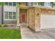 Inviting front entry featuring stone accents and a stylish red door for a warm welcome at 5136 S Ceylon St, Centennial, CO 80015