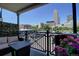 Relaxing balcony featuring outdoor seating, a grill, and vibrant flowers with skyline view at 1727 Pearl St # 205, Denver, CO 80203