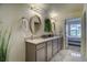 Well-lit bathroom featuring dual sinks with modern fixtures and decorative mirrors at 1727 Pearl St # 205, Denver, CO 80203