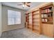 Bright bedroom featuring a large window and built-in bookshelves with ample storage at 1727 Pearl St # 205, Denver, CO 80203