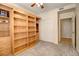 Bedroom featuring large built-in shelving, ceiling fan, and closet at 1727 Pearl St # 205, Denver, CO 80203