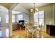 Open-concept dining area with hardwood floors adjacent to a work area and living space at 1727 Pearl St # 205, Denver, CO 80203