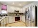 Contemporary kitchen featuring stainless steel appliances, granite counters, and ample cabinet space at 1727 Pearl St # 205, Denver, CO 80203